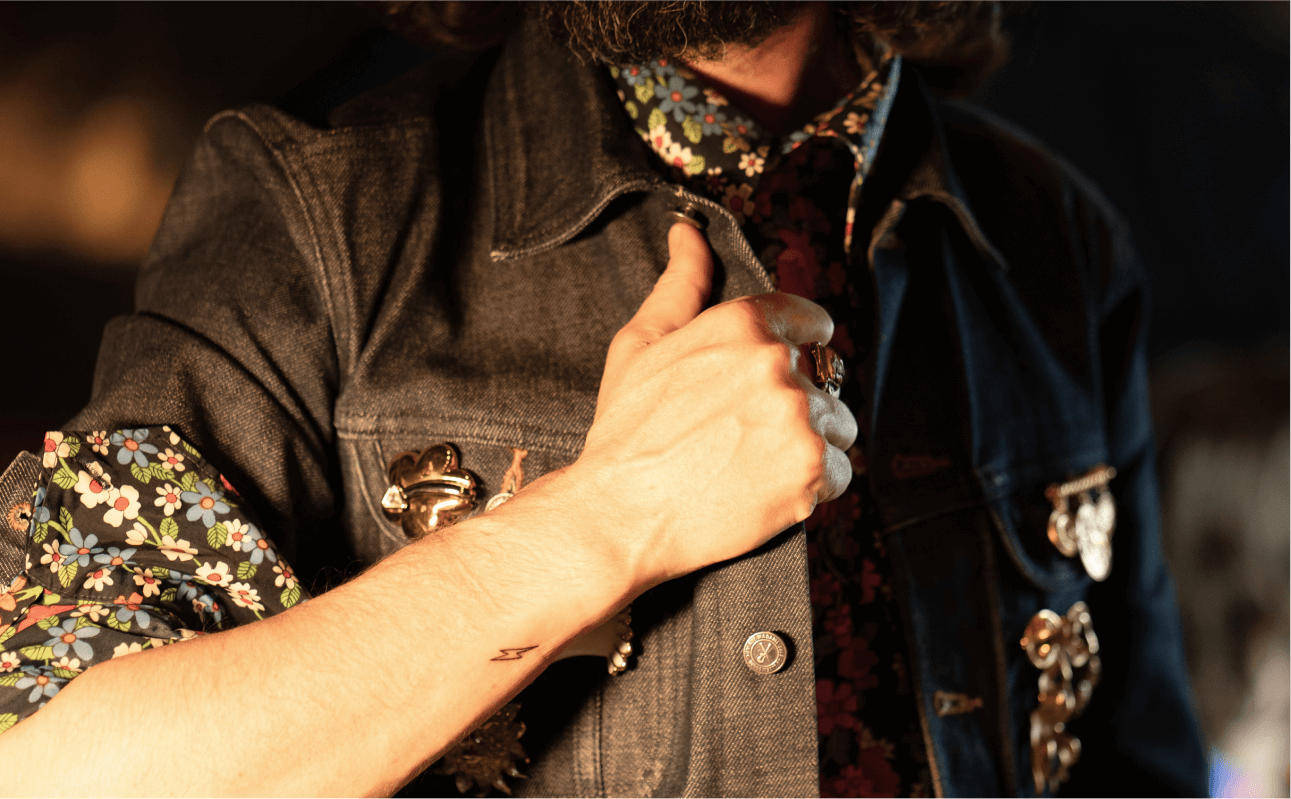 Happy clients proudly displaying their freshly completed tattoos at a live tattoo event, with unique and personalized designs.